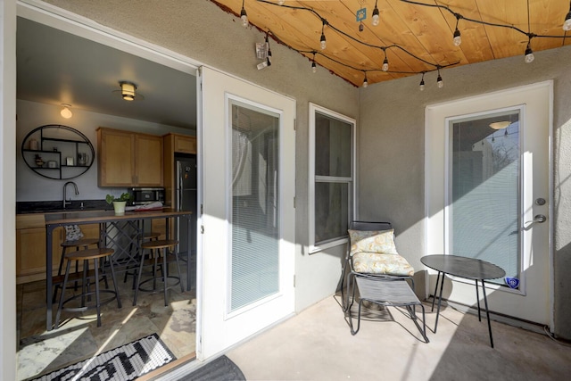 view of patio / terrace with outdoor dry bar and a sink