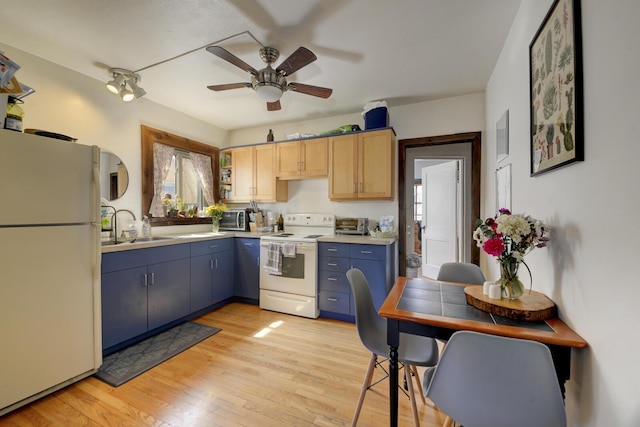 kitchen with light countertops, light wood-style floors, a sink, blue cabinets, and white appliances