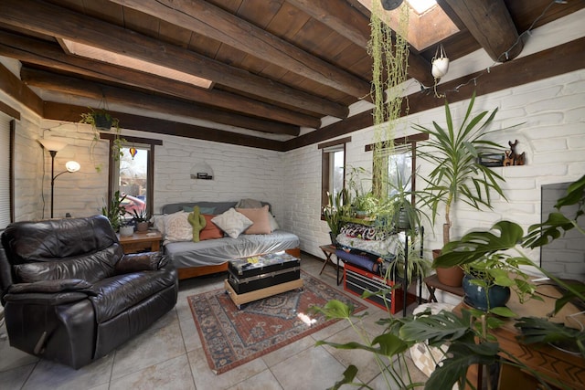 tiled living area featuring wood ceiling, brick wall, a skylight, and beam ceiling