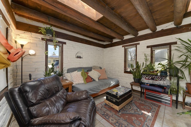 living area featuring wooden ceiling, beamed ceiling, brick wall, and tile patterned floors