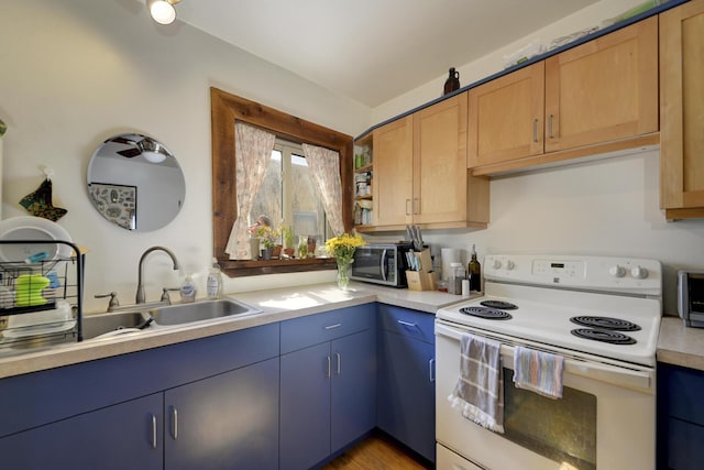 kitchen with white electric stove, light countertops, a sink, and blue cabinets