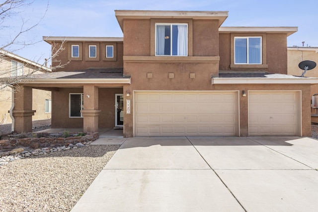 view of front of home with concrete driveway, a garage, and stucco siding