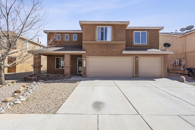 view of front of house with stucco siding, driveway, and a garage