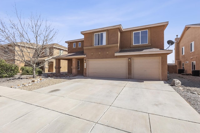 view of front of property featuring stucco siding, a garage, and concrete driveway