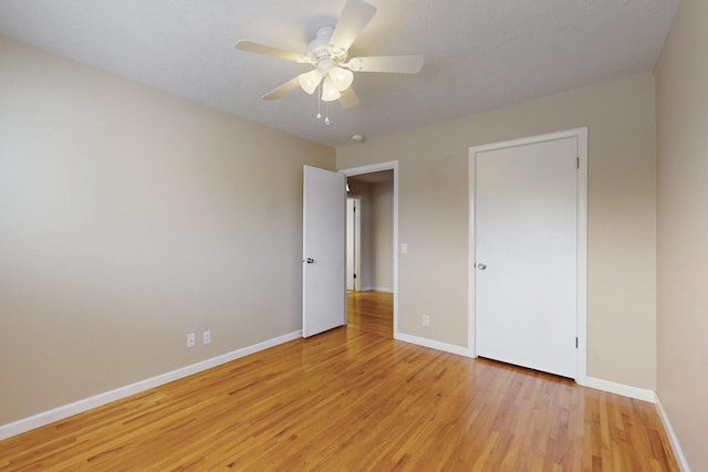 unfurnished bedroom with a ceiling fan, baseboards, and light wood finished floors