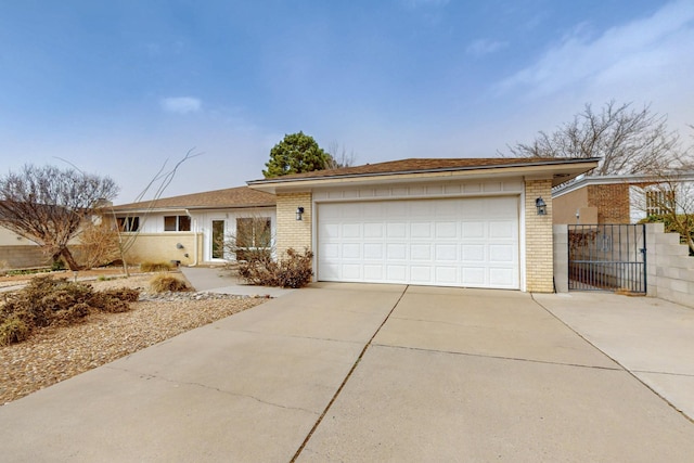 ranch-style home with brick siding, driveway, and a garage