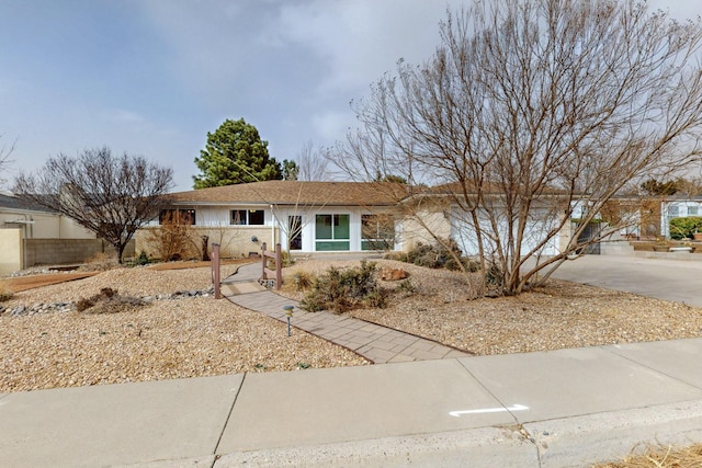 ranch-style home featuring concrete driveway