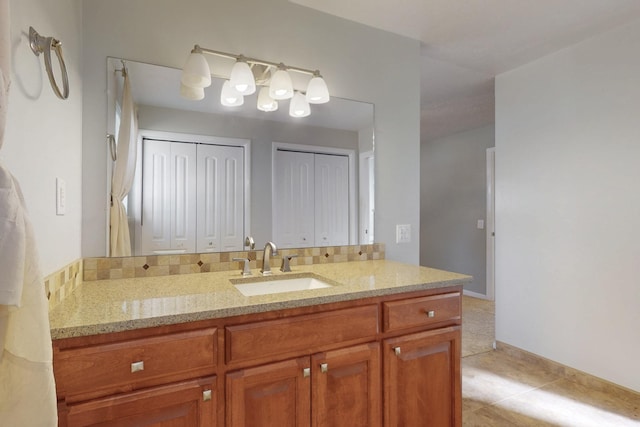 bathroom featuring tile patterned floors, vanity, and baseboards