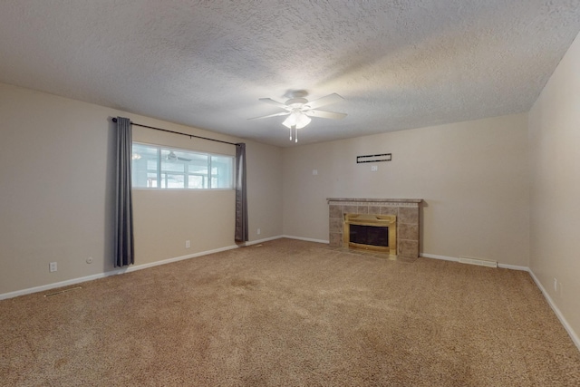 unfurnished living room featuring visible vents, a ceiling fan, a fireplace, and carpet