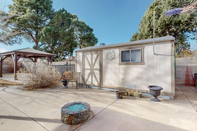 view of shed featuring a gazebo and fence