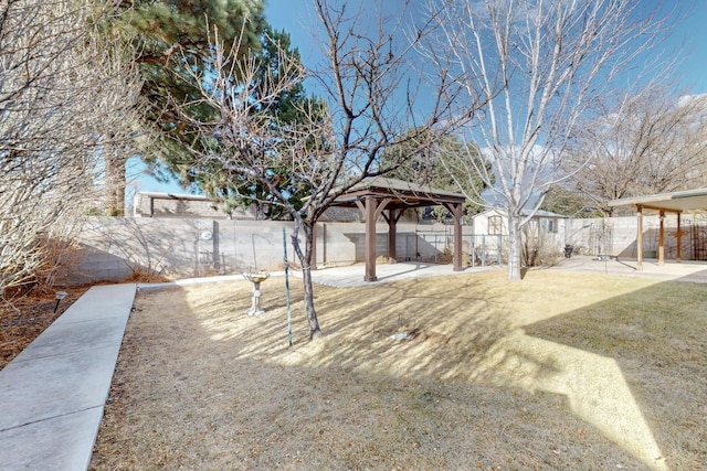 view of yard with a gazebo, a patio, and a fenced backyard