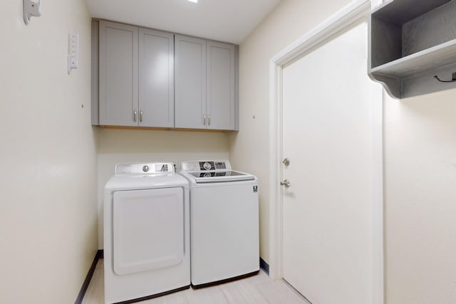 washroom featuring cabinet space and washer and dryer