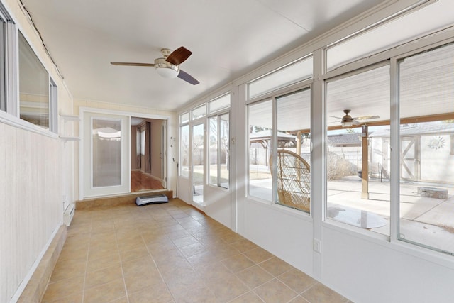 unfurnished sunroom with a baseboard radiator and ceiling fan