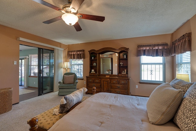 bedroom featuring a textured ceiling, carpet, ceiling fan, and access to outside