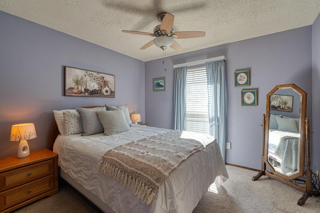 bedroom featuring a ceiling fan, light colored carpet, baseboards, and a textured ceiling