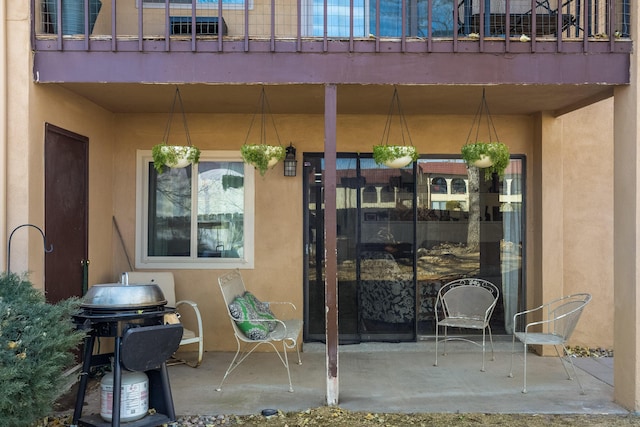 view of patio featuring a balcony and a grill