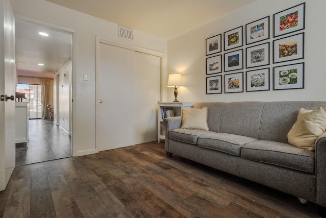 living area with recessed lighting, visible vents, and dark wood-style flooring