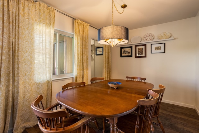 dining room with baseboards and wood finished floors