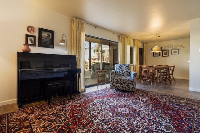 sitting room with baseboards and wood finished floors