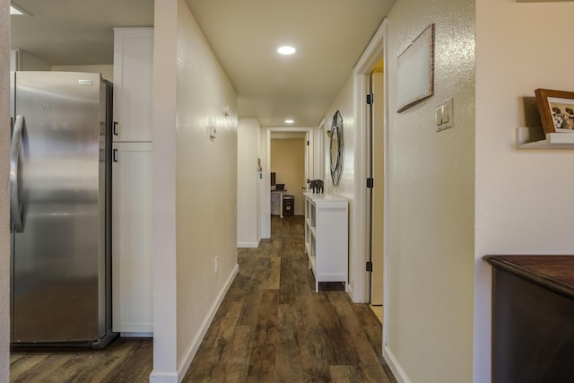 hall featuring dark wood finished floors, recessed lighting, and baseboards