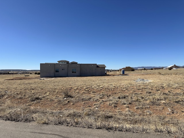 view of yard with a rural view