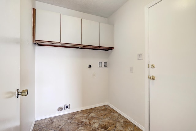 washroom featuring baseboards, washer hookup, cabinet space, hookup for an electric dryer, and a textured ceiling