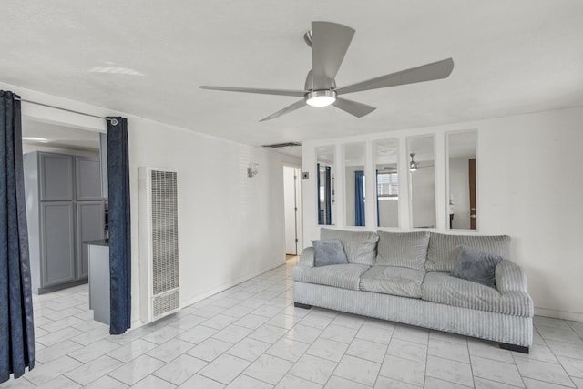 living room with visible vents, a heating unit, and a ceiling fan