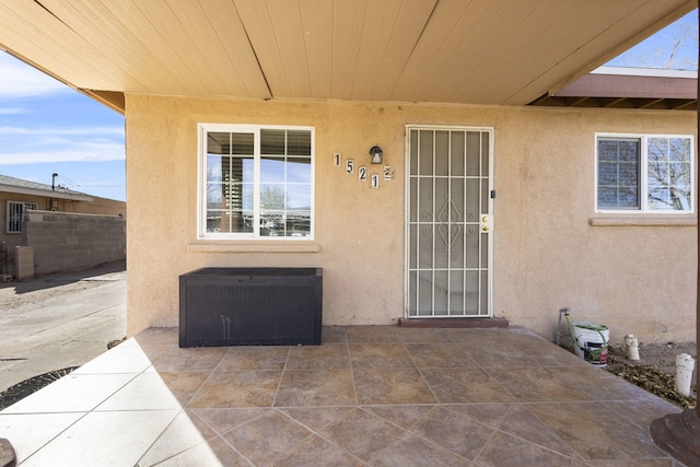 exterior space featuring a patio area, stucco siding, central AC, and fence