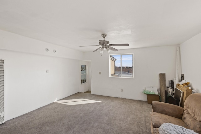 unfurnished living room with light colored carpet and ceiling fan