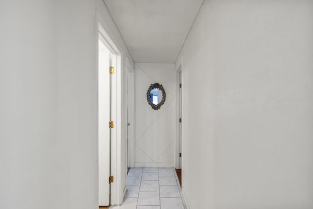 hallway with marble finish floor