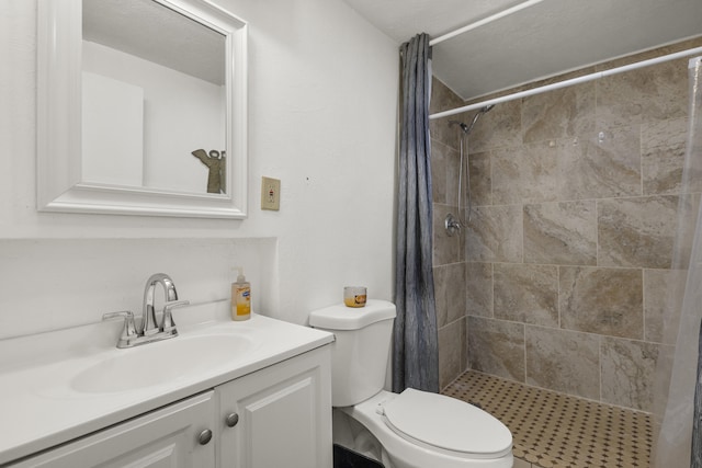 full bathroom with vanity, toilet, and a shower stall