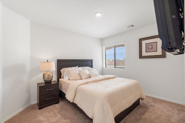 bedroom featuring visible vents, light colored carpet, and baseboards