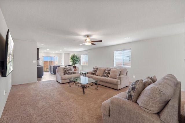 living room with recessed lighting, light colored carpet, baseboards, and a ceiling fan