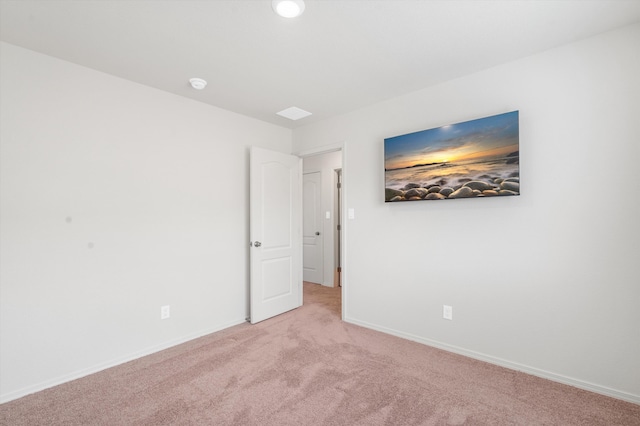 empty room with baseboards and carpet