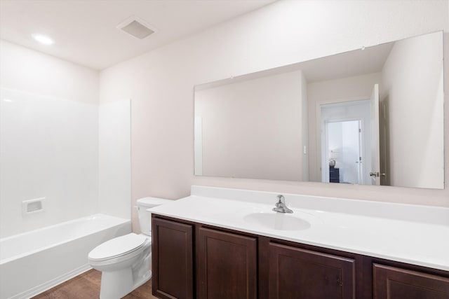 bathroom with visible vents, toilet, wood finished floors, and vanity