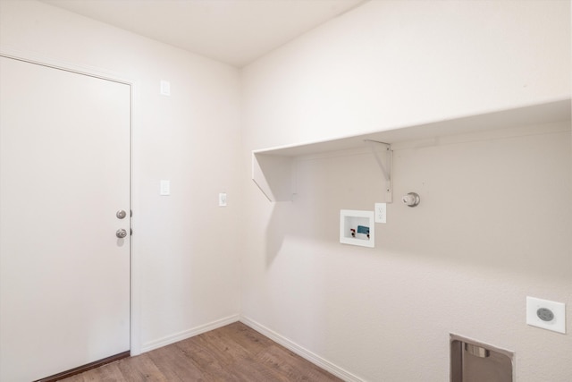 laundry room featuring hookup for a washing machine, light wood finished floors, laundry area, electric dryer hookup, and hookup for a gas dryer