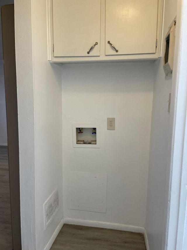 laundry room featuring dark wood-style floors, washer hookup, cabinet space, and baseboards