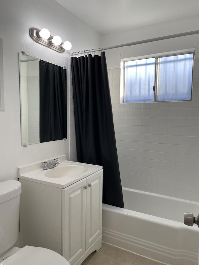 bathroom featuring toilet, tile patterned flooring, shower / bath combo, and vanity