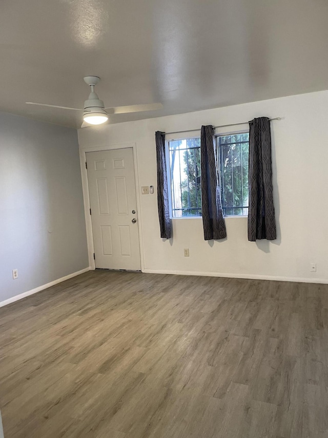 entrance foyer featuring ceiling fan, wood finished floors, and baseboards