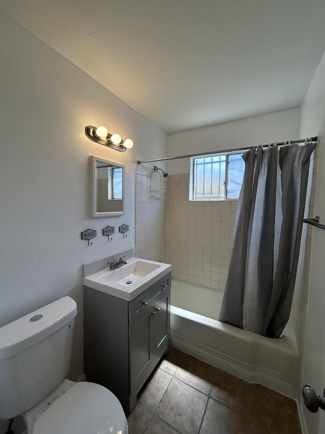 bathroom featuring shower / bath combination with curtain, vanity, toilet, and tile patterned floors