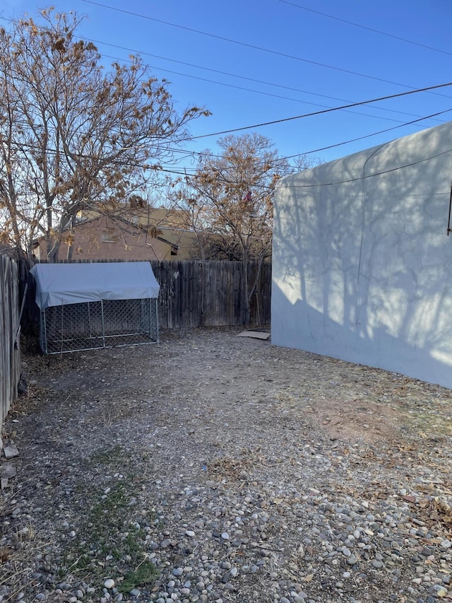 view of yard featuring a fenced backyard and an outdoor structure