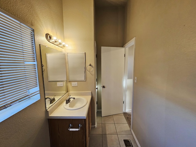 bathroom with tile patterned flooring, visible vents, vanity, and baseboards