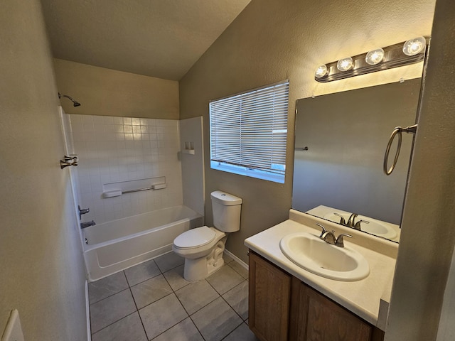 bathroom featuring vanity, washtub / shower combination, vaulted ceiling, tile patterned floors, and toilet