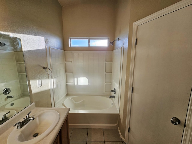 bathroom with tile patterned floors, shower / washtub combination, vanity, and a textured wall