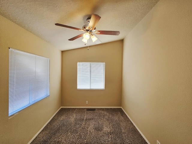 carpeted empty room featuring ceiling fan, baseboards, and a textured ceiling