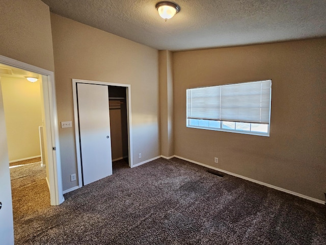 unfurnished bedroom featuring visible vents, carpet, baseboards, and a textured ceiling