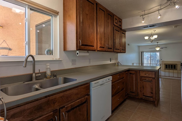 kitchen with a ceiling fan, visible vents, a peninsula, a sink, and dishwasher