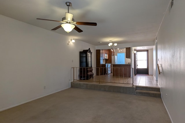 unfurnished living room with visible vents, light carpet, and baseboards