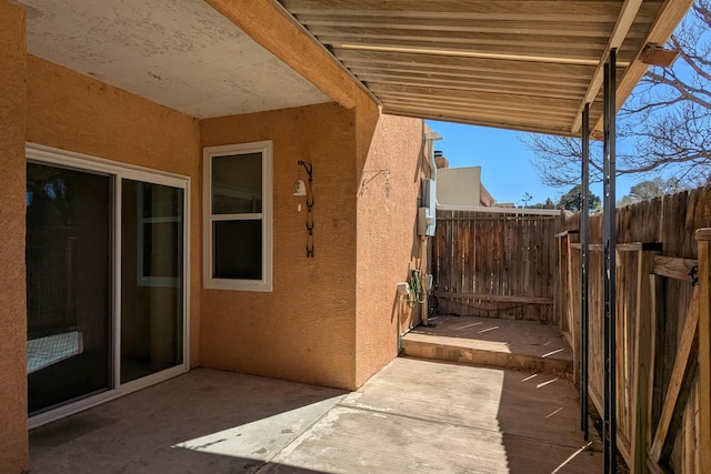 view of patio featuring fence