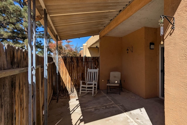 view of patio featuring fence